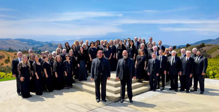 The choir standing in front of a skyline.